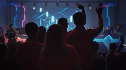 Esport Team of Professional Gamers Enter Video Game Championship Arena. Cyber Games Tournament Event with Crowd of Fans and Spectators Cheering for Favourite Players. Slow Motion
