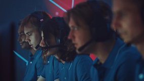 Professional Gamers Play Computer Video Game Talking into Headset with Teammates on a Championship. Diverse Esport Team of Pro Gamers Play in Computer Game. Cyber Games Arena. Handheld Close-up
