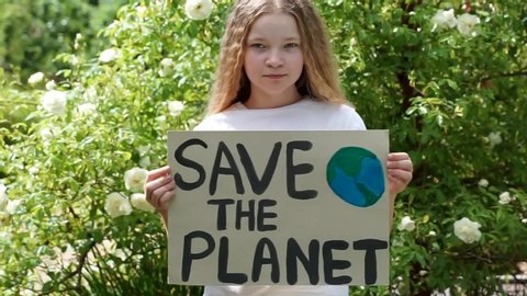 cute young girl standing with Save planet Poster on school backyard. teen kid child volunteer protest against earth pollution, global warming, recycle.earth day, no war in world, save peace strike