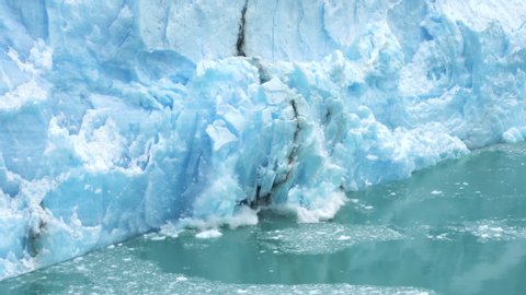 Glacier Ice Collapse Into Ocean Water, Close Up. Global Warming and Climate Change Concept