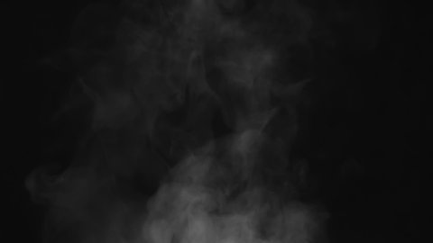 White Steam Flow on Black Screen. White Steam rises from a large pot that is behind the scenes. Black background. Filmed at a speed of 240fps