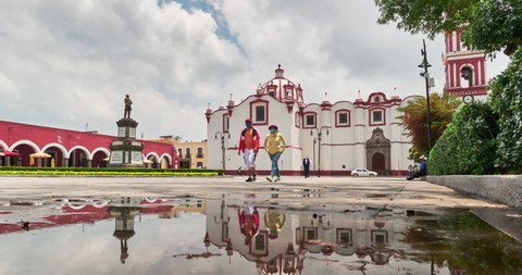 Motion time lapse of Plaza de La Concordia with monument and porch of the Town Hall with in center of San Pedro Cholula at the time of coronavirus, Mexico, July 25, 2020