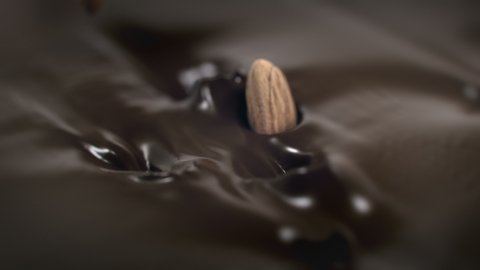 Almonds Nuts Splash Into Liquid Chocolate in 4K Super slow motion