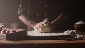Senior professional chef kneading floured dough at bakery, mature retiree enjoying hobby making homemade bread using traditional recipe isolated on black background close up 4k footage - Powered by Shutterstock - Get 15% off with code: PIKWIZARD15