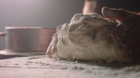 Closeup shot of hands of senior bakery chef applying flour on dough, old man kneading dough, making bread using traditional recipe, isolated on black background 4k footage - Powered by Shutterstock - Get 15% off with code: PIKWIZARD15