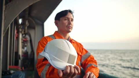 Filipino deck Officer on deck of vessel or ship , wearing PPE personal protective equipment.
