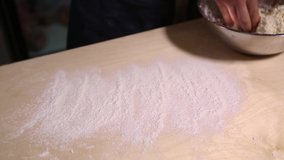 Cook rolling fresh white cottage cheese in wheat flour in close up video clip.Russian chef cooks traditional syrniki dish in closeup footage in restaurant kitchen