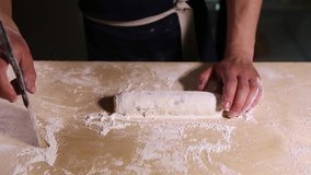 Cook prepars cheesecakes with fresh cottage cheese & wheat flour on wooden table in restaurant kitchen.Close up video clip of cooking process of traditional Russian syrniki dish