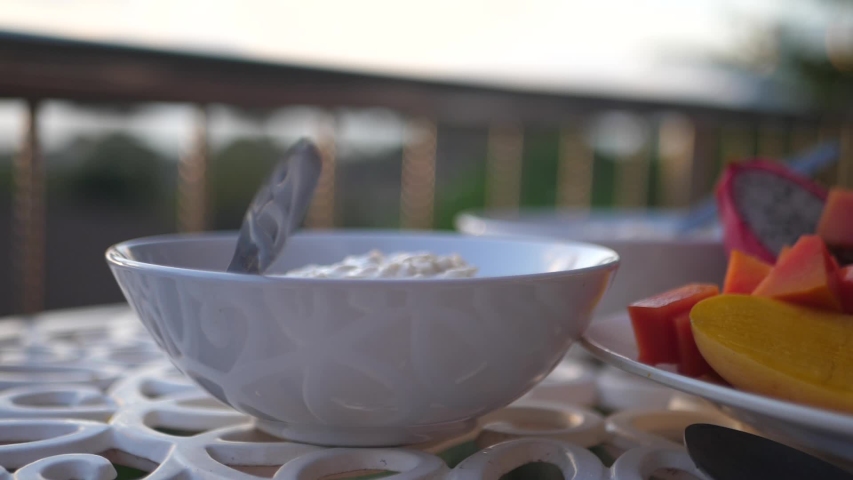 Delicious sunrise breakfast with oatmeal, mango, papaya and dragon fruit. 1920x1080. full hd