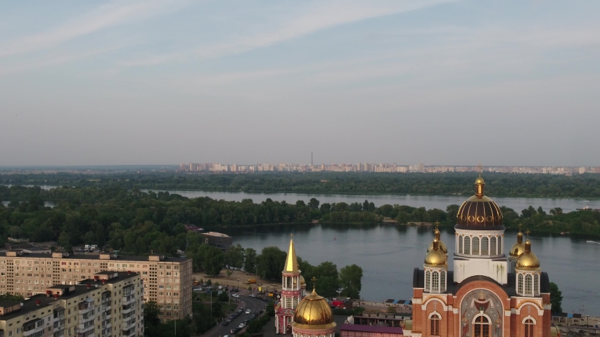 Aerial view of St.Pokrovskiy Cathedral in Kiev, Ukraine. Obolonskaya embankment. The Church is located on the banks of the Dniepo river.
