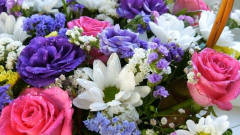 A beautiful stylish bouquet of various multi-colored flowers of daisies, roses, dried flowers. Festive bridal bouquet of white, pink, blue, purple, yellow flowers.