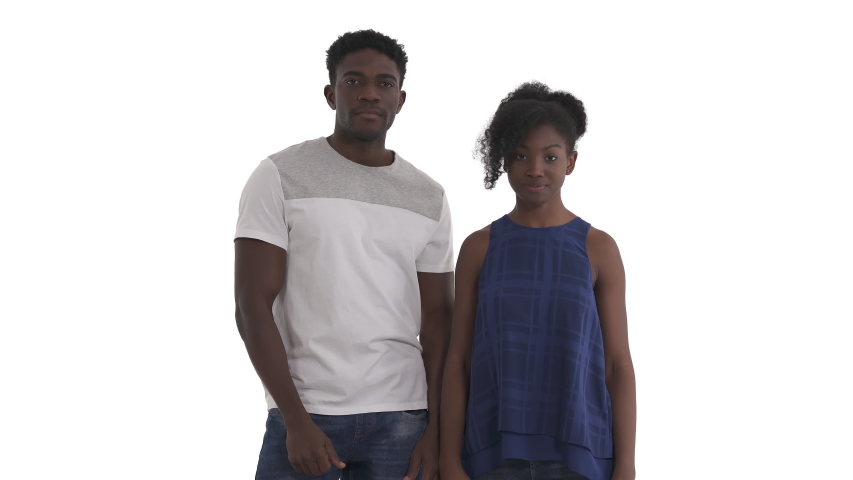 Portrait of smiling African American couple forming shape of heart using their fingers on both hands and showing its to camera isolated on white background. Hand heart love sign