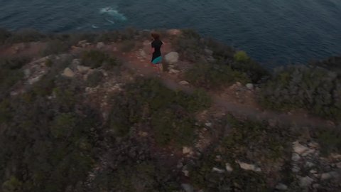 Trail Running on a Cliff next to the Sea, Top Down View