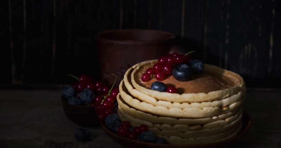 Sweet pancakes blueberry and redcurrant topping. Homemade pancakes with berries and coconut flakes