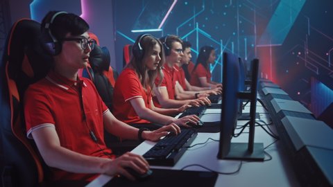 Diverse Esport Team of Pro Gamers Play in Mock-up RPG Strategy Video Game on a Championship. Stylish Neon Cyber Games Arena. Online Broadcasting of Tournament Event. Arc Side View