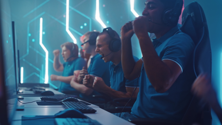 Diverse Esport Team of Pro Gamers Playing in Video Game, use Headsets to Talk, Win Championship and Celebrate with High-Five. Stylish Neon Cyber Games Arena. Online Broadcasting of Tournament Event