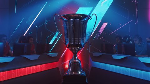 Two Esport Teams of Pro Gamers Play to Compete in Video Game on a Championship. Stylish Neon Cyber Games Online Streaming Tournament Arena with Trophy in the Center. Elevating Crane Shot