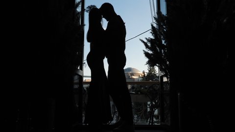 Passionate Caress, Sensual Intimacy Desire of Hugging Sexy Couple Standing on Restaurant Balcony for Romantic Evening Date Indoors. Love Feelings of Young Girlfriend and Boyfriend Enjoying Each Other