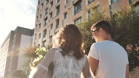 Young Happy Couple Walks Along City from Market to Home Discussing Food Purchase Together. Positive Friendly Communication, Funny Grocery Shopping of Girl and Guy Carrying Packets Outdoors on Sun Day - Powered by Shutterstock - Get 15% off with code: PIKWIZARD15