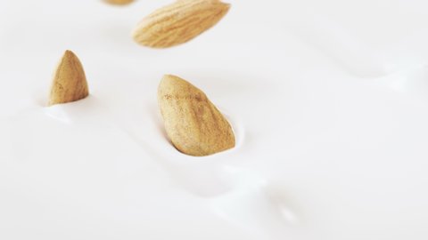 Almonds Nuts Falling Into Liquid Yoghurt in 4K Super slow motion