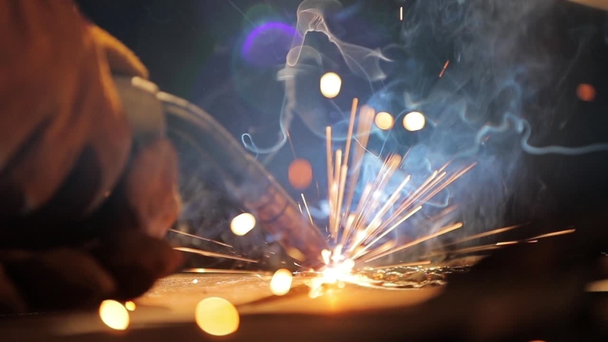 Closeup of a welding machine in work. Worker welds metal. | Shutterstock HD Video #1056699185