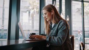 Young woman working on laptop computer at a cafe. Caucasian female influencer in a coffee shop using a laptop.
 - Powered by Shutterstock - Get 15% off with code: PIKWIZARD15