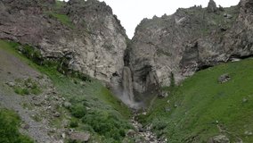 dirty waterfall sultan high in the mountains near elbrus in summer in the north caucasus in dzhilusu