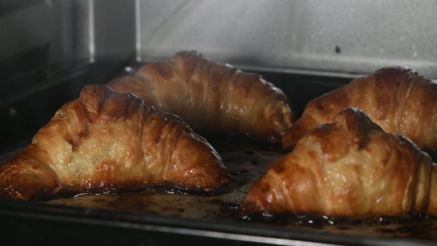 A time lapse video of croissants baking in the oven