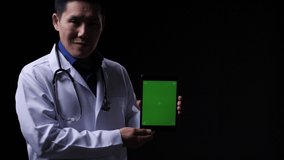 Doctor posing and looking at camera with presentation data tablet green screen. Doctor working about treatment system, prescription digital and diagnostic service. Display green screen or chroma key. - Powered by Shutterstock - Get 15% off with code: PIKWIZARD15