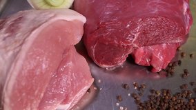 Video clip of red beef meat & pink pork steak prepared for cooking in restaurant kitchen.Natural food ingredients with protein filmed in closeup 