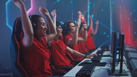 Beautiful Young Female Gamer Plays Computer Video Game with Her Esports Team on a Cyber Championship. Stylish Neon Cyber Arena 
