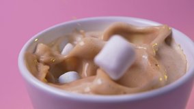 Pile of sweet colored marshmallows dropping into purple cup with delicious hot chocolate cocoa drink isolated. Pink background. Warm-up beverage. Close-up. - Powered by Shutterstock - Get 15% off with code: PIKWIZARD15
