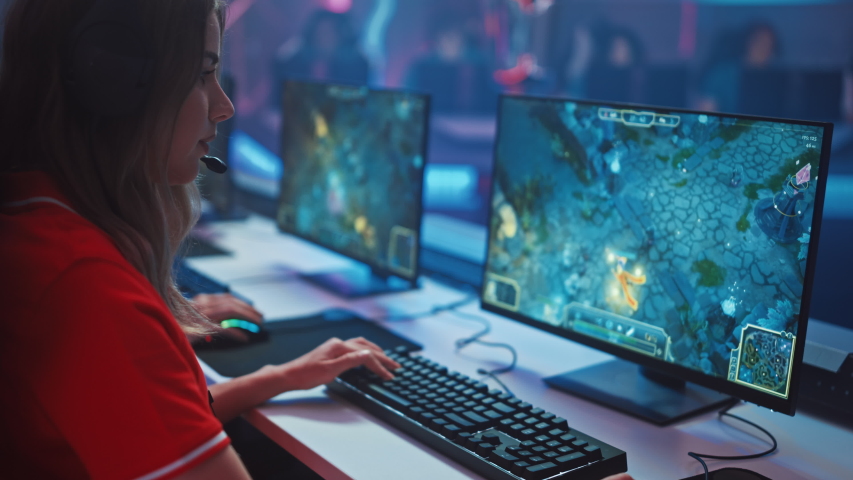 Beautiful Young Female Gamer Plays  RPG Video Game on a Championship. Diverse Esport Team Play in Mock-up Video Game. Stylish Neon Cyber Games Arena. Side Arc View | Shutterstock HD Video #1056738485