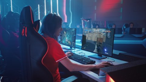 Beautiful Young Female Gamer Plays Computer Video Game FPS Shooter on a Championship. Diverse Esport Team of Play in Mock-up Video Game. Stylish Neon Cyber Games Arena. Side Arc View
