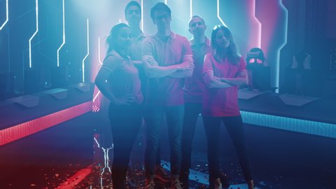 Diverse Gamers Esport Team Steps forward on a Stage Ready to Win Video Games Tournament, Posing at Tough Guys and Girls. Stylish Neon Championship Arena for Online Streaming of Cyber Games