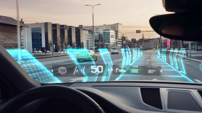 Futuristic Concept:  Autonomous Self-Driving Car Moving Through City, Head-up Display HUD Showing Infographics: Speed, Distance, Navigation. Road Scanning. Driver Seat  POV  First Person View FPV
 Royalty-Free Stock Footage #1056741539