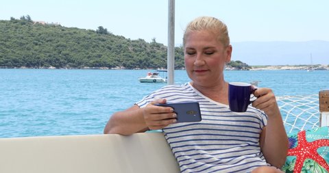 Portrait of a caucasian female tourist woman on luxury yacht relaxing and looking around at summer vacation
