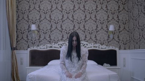 Zombie bride sitting up on bed, rise of the dead, paranormal activity, spirit