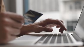 Close-up of the finger, Young man pressed the credit card code to pay online via the laptop at the desk in the room, Online purchases and use of credit cards concept. - Powered by Shutterstock - Get 15% off with code: PIKWIZARD15
