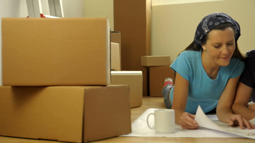 Young couple making projects in their new home;  HD: Photo JPEG, dolly.