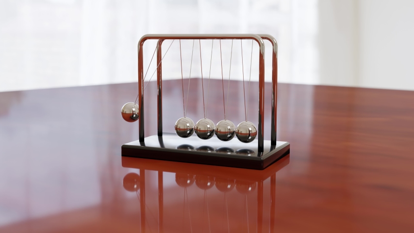 Newton's cradle swinging on a wooden table with light background. Loop. Balance concept. Royalty-Free Stock Footage #1056759914