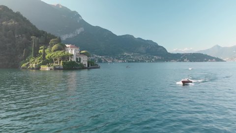 newlyweds ride on a motorboat in lake como - Arial shot