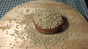 green lentils Earth composition in ceramic bowl on wooden board made 4K video shot Macro video rotating great conceptual green lentil shoot buying now.