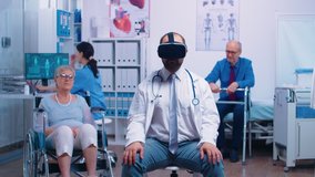Doctor wearing VR headset, diagnosing senior woman problems while she sitts in a wheelchair in the back. Futuristic medicine, health care of the future in private clinic or hospital - Powered by Shutterstock - Get 15% off with code: PIKWIZARD15