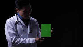 Doctor posing and looking at camera with presentation data tablet green screen. Doctor working about treatment system, prescription digital and diagnostic service. Display green screen or chroma key. - Powered by Shutterstock - Get 15% off with code: PIKWIZARD15