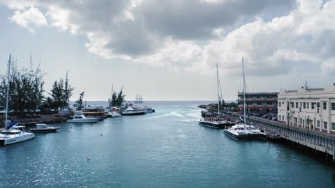 Aerial view of the bay with yacht and dancing people on a boat in Bridgetown, Barbados