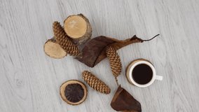 Cup of black coffee with marshmallow and dried branches on wooden table background.