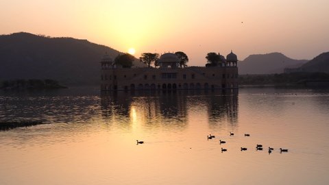Jal Mahal Water Palace Jaipur. Pink city sunrise panoramic. Sunset 4k footage of beautiful palace in historic city. Palace on Man Sagar lake in Japur, Rajasthan, India