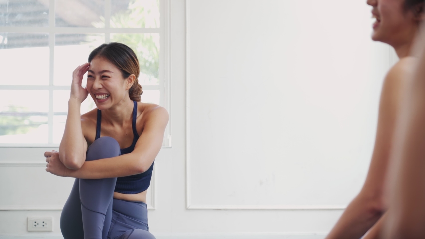 Young Asian group sporty attractive people learning yoga lesson with coach trainer. Instructor woman relax talking to students friendly in fitness studio. Sport gymnastics, ballet dancing class. - Powered by Shutterstock - Get 15% off with code: PIKWIZARD15