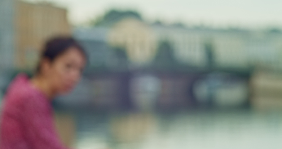 lady in red dress next to the bridge on the Moika river in Saint Petersburg